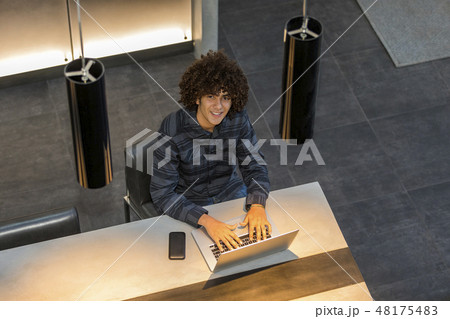 Teenage boy with laptop in cafe Teenage boy with laptop in cafe 48175483