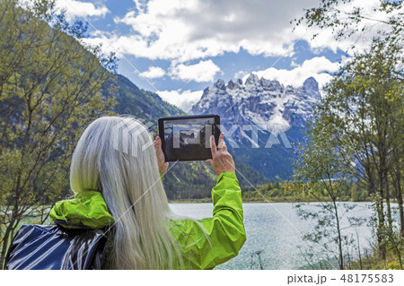 Woman photographing with digital tablet Tre Cime di Lavaredo, Italy 48175583