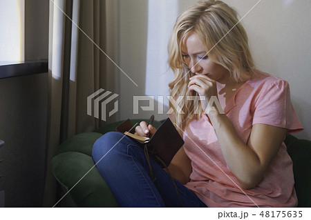 Woman writing in notebook Woman writing in notebook 48175635