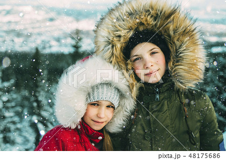 Girls with fur hoods during winter 48175686