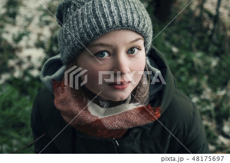 Woman with woolly hat in forest during winter 48175697