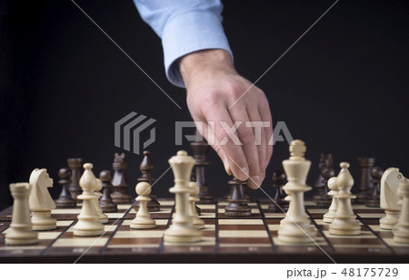 Hand of man playing chess Hand of man playing chess 48175729