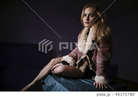 Young woman sitting on bed 48175780