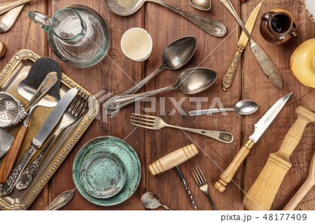 An overhead photo of many vintage kitchen objects and cutlery from an old restaurant, flea market An overhead photo of many vintage kitchen objects and cutlery from an old restaurant, flea market 48177409