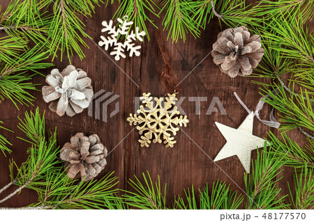Christmas greeting card with fir tree branches, cones, snow, and xmas decorations Christmas greeting card with fir tree branches, cones, snow, and xmas decorations 48177570