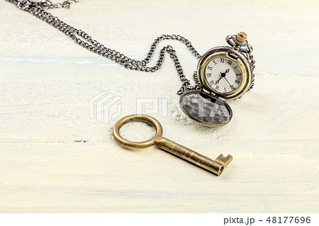 A photo of a vintage key and chain watch, with copy space 48177696