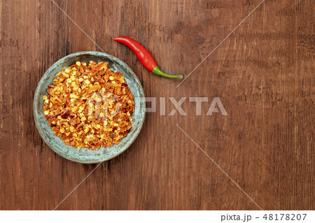 Red hot pepper, crushed and fresh chili, overhead photo with copy space Red hot pepper, crushed and fresh chili, overhead photo with copy space 48178207
