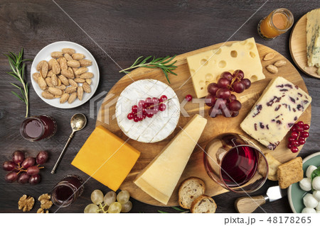 Various types of cheese with wine on a rustic background 48178265