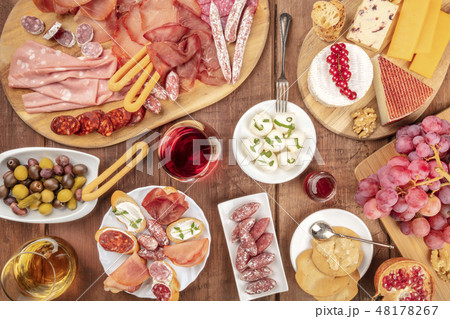 Charcuterie Tasting. Many different sausages and hams, deli meats, and a cheese platter, shot from 48178267