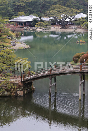 冬の栗林公園、南湖の偃月橋と薄雪の掬月亭 48183336