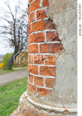 An oil column of red brick in an abandoned manor house. Rukavishnikov manor in the village of An oil column of red brick in an abandoned manor house. Rukavishnikov manor in the village of 48183584