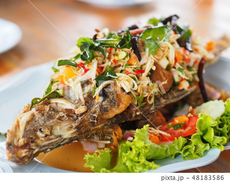 Fried fish with mixed herb on dish Fried fish with mixed herb on dish 48183586