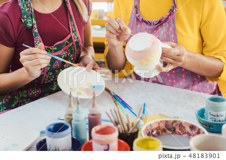 Women in DIY workshop coloring and decorating their own ceramic Women in DIY workshop coloring and decorating their own ceramic 48183901