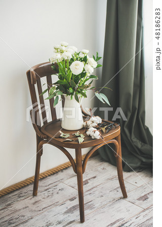 Spring white buttercup flowers in enamel jug on 48186283