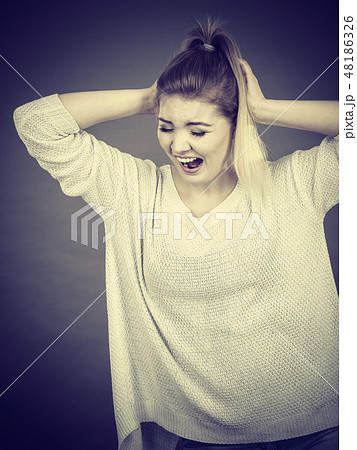 Unhappy woman screaming and yelling in pain Unhappy woman screaming and yelling in pain 48186326