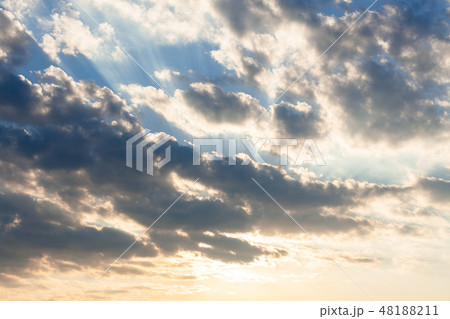 Clouds and sunrays at sunrise 48188211