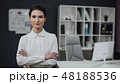 Businesswoman standing, office interior on background, female. 48188536