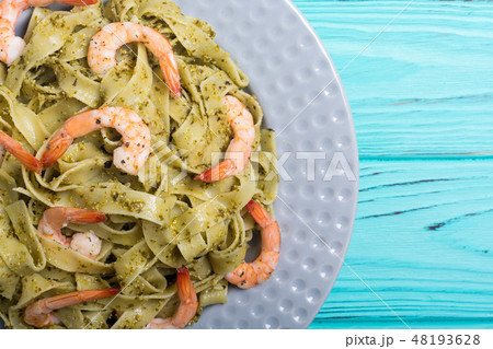 Pasta tagliatelle with sauce pesto and shrimps 48193628