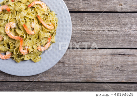 Pasta tagliatelle with sauce pesto and shrimps 48193629