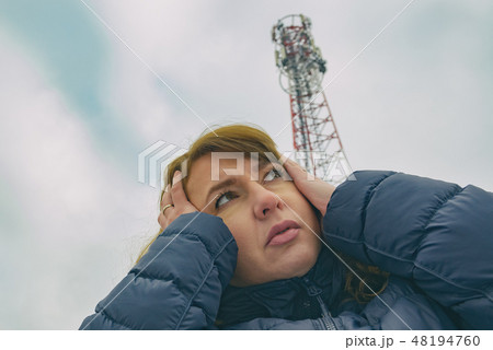 Woman is holding her head near the BTS 48194760