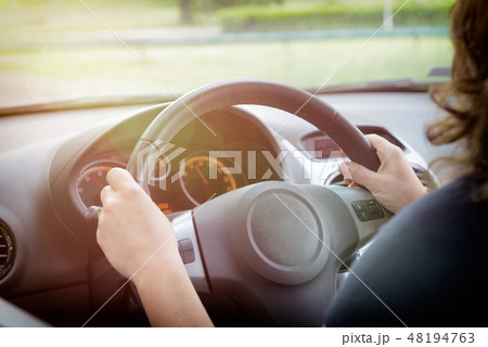 Woman driving a car, view from behind 48194763