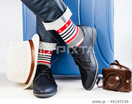 Stylish suitcase, men's legs, multicolored socks Stylish suitcase, men's legs, multicolored socks 48195536