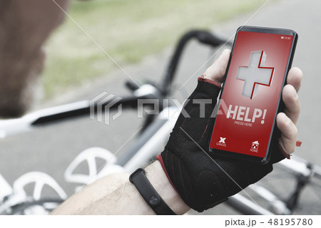 Injured biker holding smartphone calling rescue Injured biker holding smartphone calling rescue 48195780