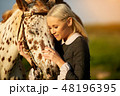 oil painting in rococo time. Sensual woman embracing horse in sunlight 48196395