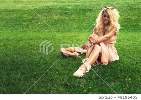 eauty blonde alone young woman resting in the park 48196405