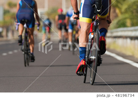 Cycling competition cyclist athletes riding a race 48196734