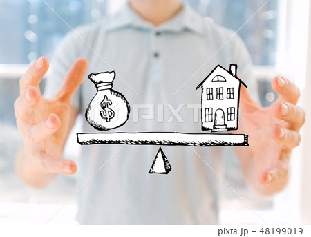 House and money on the scale with young man 48199019