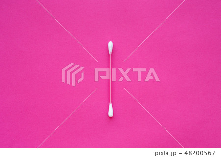 pink cotton buds with white heads laid out on pink 48200567