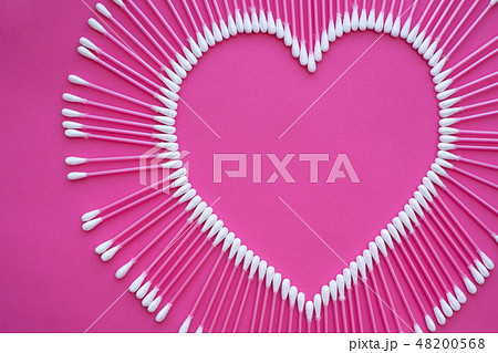 cotton buds laid out in the shape of a heart on  48200568