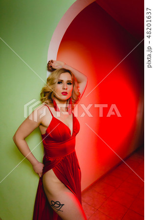 Close-up portrait of sexy blonde woman in the red dress in a studio Close-up portrait of sexy blonde woman in the red dress in a studio 48201637