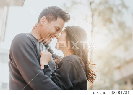 Asian couple in love embracing outdoor 48201781