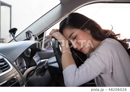 Tired young woman sleep in car 48206026