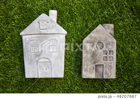 Stone mockup houses on green grass 48207987