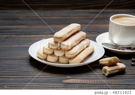 Italian Savoiardi ladyfingers Biscuits and cup of coffee on wooden backgound 48211922