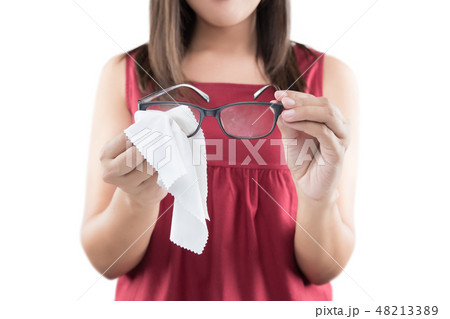 Asian woman hand cleaning glasses lens Asian woman hand cleaning glasses lens 48213389