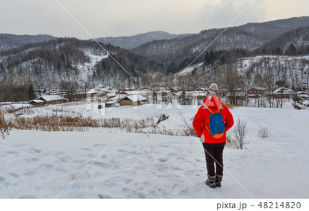 Woman walking at snow village in China Woman walking at snow village in China 48214820