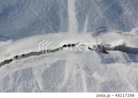 Crack on the snow river in the spring 48217286