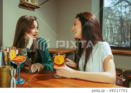 Friends having a drinks at bar 48217701