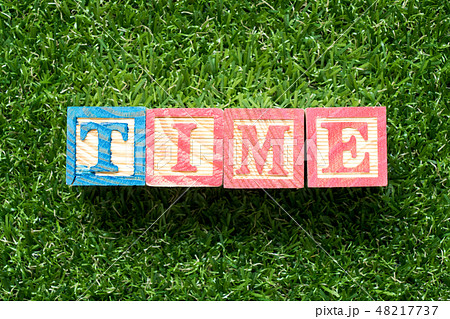 Color wood block in word time on green grass Color wood block in word time on green grass 48217737