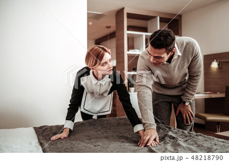 Hotel maid feeling discriminated while client touching her hand Hotel maid feeling discriminated while client touching her hand 48218790