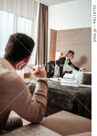 Blonde housekeeper working hard while man observing her Blonde housekeeper working hard while man observing her 48218792