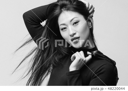 asian model in black jacket posing in studio 48220044