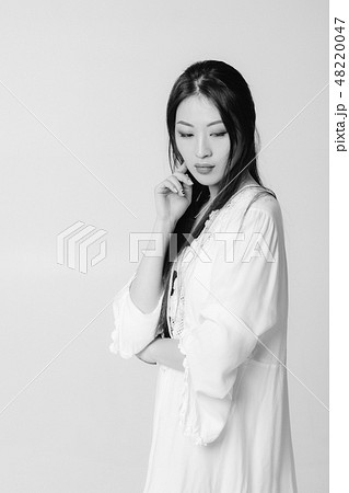beautiful asian woman in white shirt posing in studio. beautiful asian woman in white shirt posing in studio. 48220047