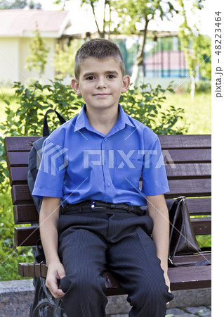 Cute boy are sitting on the bench Cute boy are sitting on the bench 48223464