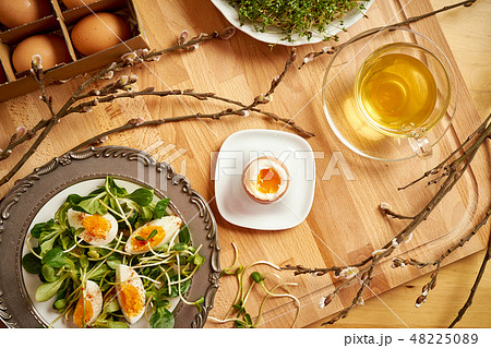 Spring and Easter breakfast with eggs and cress sprouts with tea and sprouts on wooden background Spring and Easter breakfast with eggs and cress sprouts with tea and sprouts on wooden background 48225089