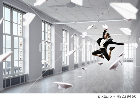 Dancing businesswoman in office Dancing businesswoman in office 48229460